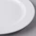 A close up of a Libbey white porcelain plate with a small rim.