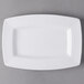 A white rectangular Libbey Slenda porcelain plate with a wide rim on a gray surface.