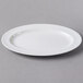 A Libbey white porcelain oval platter on a gray surface.
