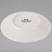 A white Tuxton China bread and butter plate with embossed black text.