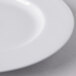 A close-up of a Libbey white porcelain plate with a wide white rim.