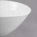 A close-up of a Libbey round white porcelain bowl with a rim.