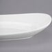 A white Libbey oval porcelain plate with a curved edge.