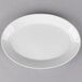 A white oval porcelain platter with a gray background.