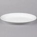 A white Libbey porcelain platter with a rim on a gray surface.