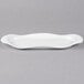 A white porcelain Libbey oval tray with curved edges.