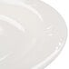 A close up of a white Royal Rideau porcelain plate with a medium white rim.