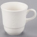 A white porcelain tea cup with a handle.