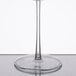 A clear Fineline Renaissance plastic champagne flute with a stem on a reflective surface.
