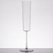 A clear plastic Fineline Renaissance champagne flute with a stem on a table.