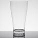 A clear Fineline plastic beer/pilsner glass on a table.