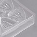 A clear plastic Matfer Bourgeat chocolate mold with triangular shapes.