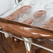 Chocolate being poured into a Martellato ribbed oval chocolate mold.