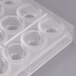 A clear plastic Chocolate World mold with 32 rose-shaped compartments.