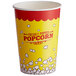 A yellow and red paper cup with popcorn.