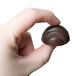 A hand holding a chocolate candy made with a Matfer Bourgeat chocolate mold.