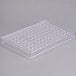 A clear plastic Matfer Bourgeat candy mold tray with small holes.