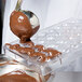 Melted chocolate being poured into a Matfer Bourgeat chocolate mold.