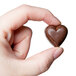 A hand holding a Matfer Bourgeat chocolate heart.