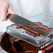 A hand cutting chocolate from a Matfer Bourgeat rabbit chocolate mold.