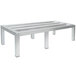 An Advance Tabco aluminum dunnage rack with four metal legs.
