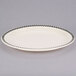 A white Homer Laughlin narrow rim oval platter with black and white checkered trim.