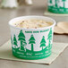 An EcoChoice paper cup of yogurt with a green and white tree design.