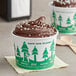 Two EcoChoice compostable paper cups of chocolate ice cream with a tree design on a counter.