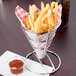 Clipper Mill stainless steel wire cone basket filled with french fries and a cup of ketchup.