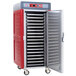 A red and silver Metro stainless steel hot holding cabinet on wheels.