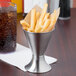 A Clipper Mill stainless steel cone basket filled with french fries.