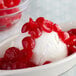 A bowl of ice cream with Regal Maraschino Cherry halves on top.
