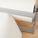 A Bulman gray steel paper dispenser with a roll of paper on a stand.