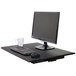 A black Luxor adjustable stand up desktop desk with a computer monitor and keyboard.