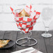 A Clipper Mill stainless steel spiral cone basket on a table with food.