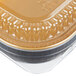 A Durable Packaging black and gold aluminum foil container with a plastic dome lid.