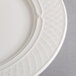 A close-up of a Homer Laughlin Kensington Ameriwhite bright white china plate with a pattern on it.