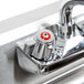 The Eagle Group underbar sink with a chrome faucet and two red handles.