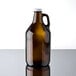 A Libbey amber glass growler with a white lid and handle.