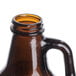 A close up of a brown Libbey beer growler with a handle.