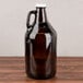 A large brown glass Libbey growler with a handle.