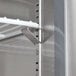 A metal shelf with white rods on a white Avantco worktop refrigerator.