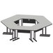 A gray and white trapezoid table with four legs.