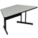 A grey trapezoid table with a black base.