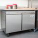 An Avantco stainless steel undercounter freezer with a door on it.