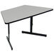 A grey trapezoid table with black legs.