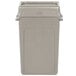 A beige Rubbermaid rectangular trash can with a beige lid.