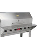A stainless steel Crown Verity barbecue grill with a removable front shelf.