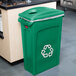 A green Rubbermaid recycling container with a green 2 hole lid.