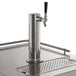 An Avantco beer kegerator with a metal beer tap on a stainless steel counter.